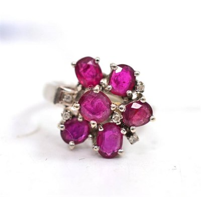 Lot 307 - Ruby and diamond cluster ring stamped '18K'