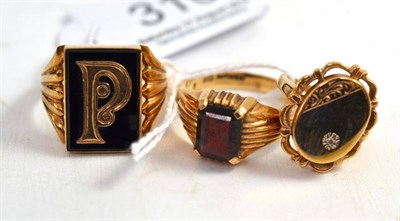 Lot 310 - An onyx signet ring with initial P stamped '9CT'; a 9ct gold garnet signet ring and a 9ct gold...