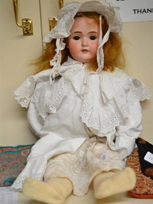 Lot 398 - Large German bisque socket head doll impressed BSW to the reverse, with pierced ears, sleeping...