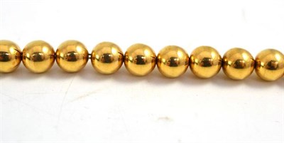 Lot 404 - A gold bead necklace