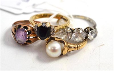 Lot 406 - A 9ct gold sapphire and diamond ring, two other 9ct gold rings and a white three stone ring,...