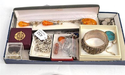 Lot 432 - A silver Albert chain with shield, an Oriental bangle, two coin bracelets, a floral ring, a pair of