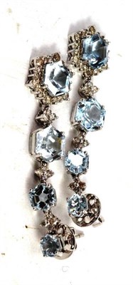 Lot 481 - A pair of blue topaz and diamond drop earrings, the graduated hexagonal shaped blue topaz spaced by