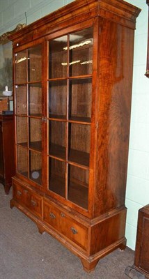 Lot 558 - A 19th century walnut glazed bookcase with two drawers to base