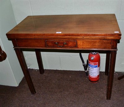 Lot 564 - A 19th century mahogany fold-over tea table with single drawer