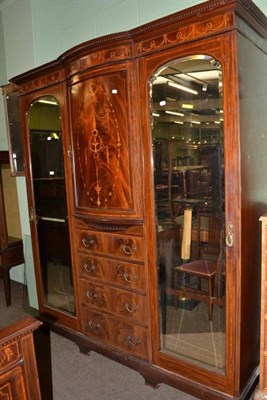 Lot 569 - An Edwardian mahogany and satinwood banded bow fronted wardrobe and a matching bedstead, three...