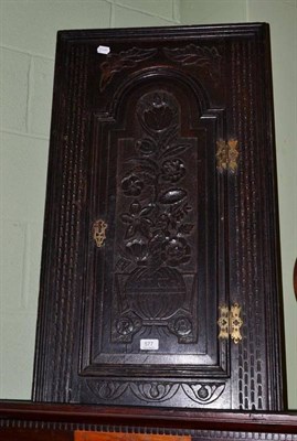 Lot 577 - An 18th century and later carved oak hanging corner cupboard