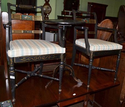 Lot 592 - A pair of black lacquered elbow chairs and a similarly decorated tripod table