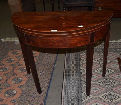 Lot 616 - A 19th century mahogany demi lune fold over card table