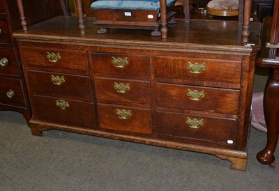 Lot 639 - A Georgian oak sideboard base with nine drawers