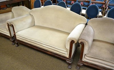 Lot 653 - An early 20th century three piece suite with caved mahogany frame with paw feet