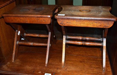 Lot 697 - Two Arts & Crafts mahogany stools, the shaped seats with bull's eye pattern, on a cross frame...