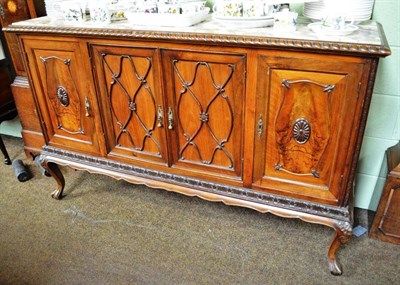 Lot 712 - An Italian walnut sideboard with paper label 'Biassoni Huigi & Figli' and marble top