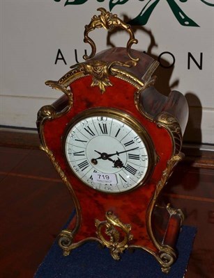 Lot 719 - A French tortoiseshell striking mantel clock, circa 1890, applied gilt metal scroll mounts,...