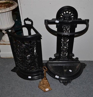 Lot 863 - Two cast iron stick stands and a door porter