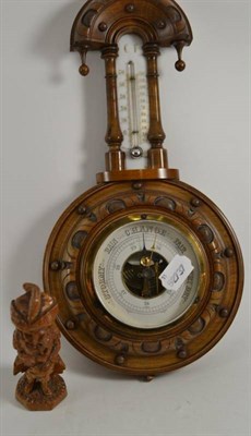 Lot 25 - A barometer and a small wooden carving of a man
