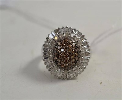 Lot 121 - A cognac and white diamond cluster ring