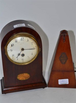 Lot 180 - An Edwardian inlaid mahogany mantel timepiece and a walnut metronome