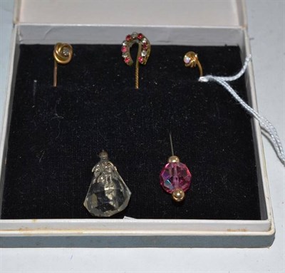 Lot 216 - An opal set stick pin, a diamond set stick pin, a paste set horseshoe stick pin and two others (5)