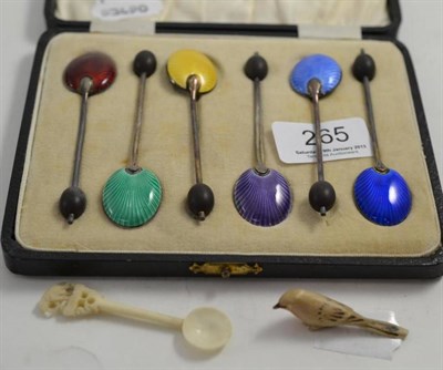 Lot 265 - A set of six silver and enamel coffee spoons, a small carved ivory bird and a spoon