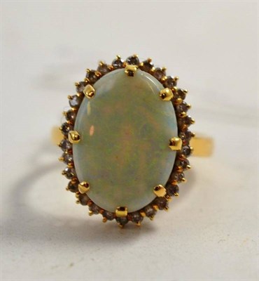 Lot 267 - An opal and diamond cluster ring, stamped '18K'