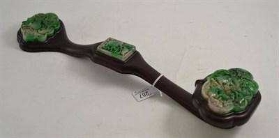 Lot 287 - A Chinese jade and hardwood ruyi sceptre in 18th century style, set with three shaped plaques...