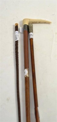 Lot 292 - A swagger stick and two whips