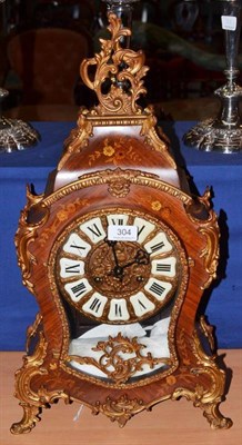 Lot 304 - A French marquetry decorated mantel clock in Louis XV style