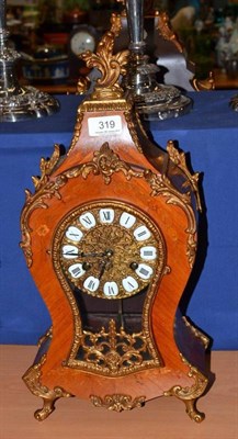 Lot 319 - A small French marquetry decorated mantel clock in Louis XV style