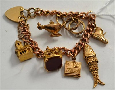 Lot 325 - A curb and lock bracelet hung with seven charms