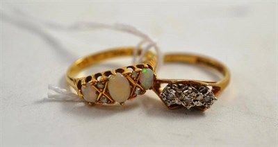 Lot 330 - An opal and diamond ring and a diamond three stone ring