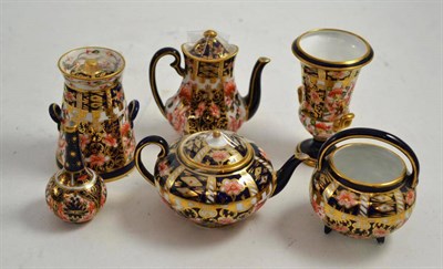 Lot 343 - Six miniature pieces of Royal Crown Derby consisting of teapot, coffee pot, vase, milk churn,...