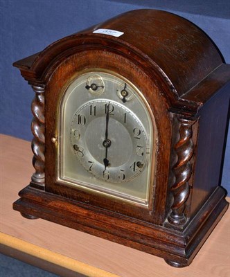 Lot 357 - A chiming mantel clock in an oak case