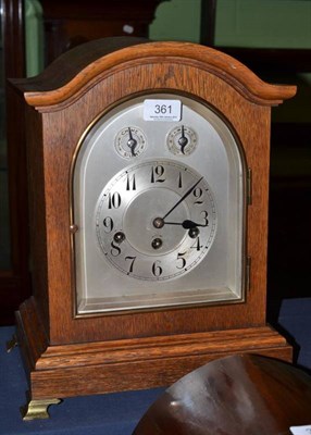 Lot 361 - A mantel clock in an oak case