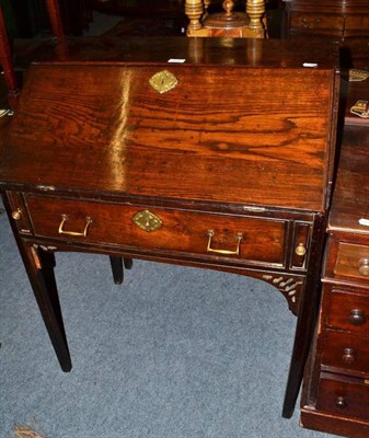 Lot 515 - A small oak bureau on square legs