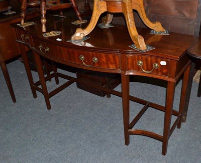 Lot 518 - A reproduction mahogany serpentine side table