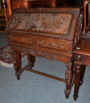 Lot 532 - A Oriental carved padouk wood bureau