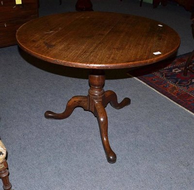 Lot 535 - A George III oak tripod tea table