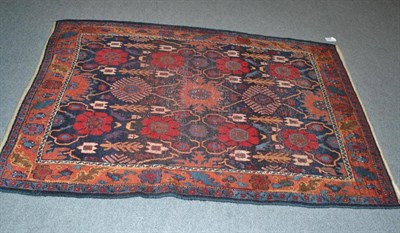 Lot 536 - Carrusu Bidjar, Persian Kurdistan the deep indigo field with columns of stylised flowerheads...