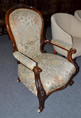 Lot 554 - A Victorian walnut framed spoon back open armchair