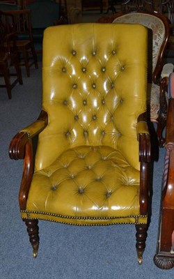 Lot 555 - A mahogany framed open armchair upholstered in brass studded buttoned mustard leather