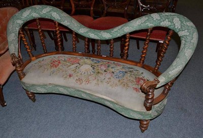 Lot 557 - A Victorian walnut scroll back settee with barley twist uprights