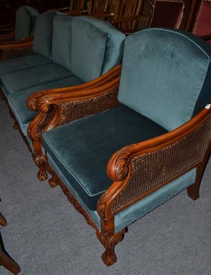 Lot 564 - A three piece bergere suite with double caned arm panels and a cane back open armchair