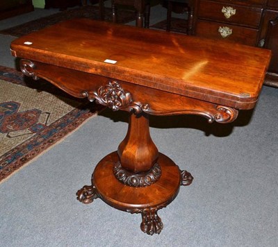 Lot 568 - A Victorian rosewood fold over pedestal card table