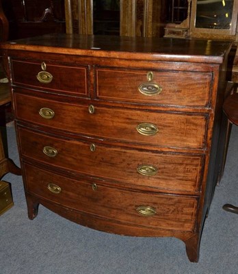 Lot 572 - A Georgian mahogany bow front four height chest