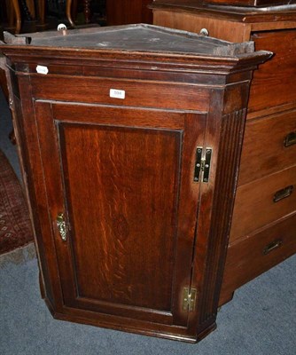 Lot 594 - A Georgian oak straight fronted corner cupboard