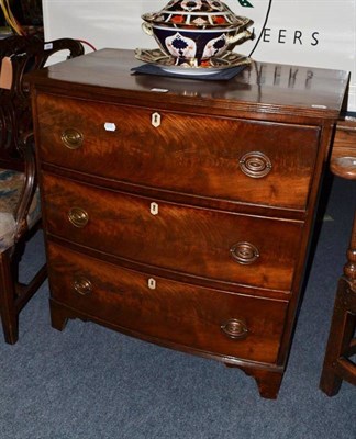 Lot 643 - A late George III mahogany bow front three height chest