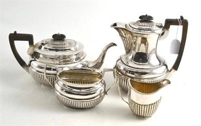 Lot 1 - A three piece silver tea service comprising teapot, sugar bowl and hot water jug and a similar...