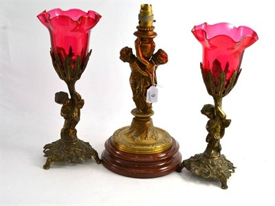 Lot 9 - Pair of brass decorative lamps with ruby shades and a figural table lamp (3)