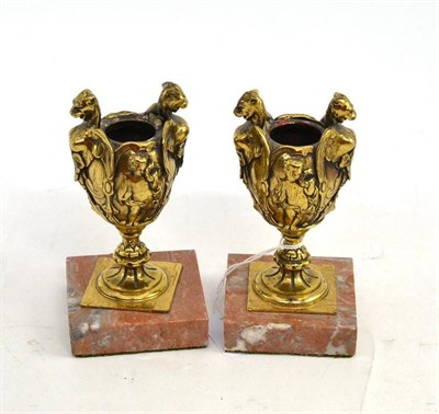 Lot 88 - A pair of gilt metal urn shaped candle holders on marble bases